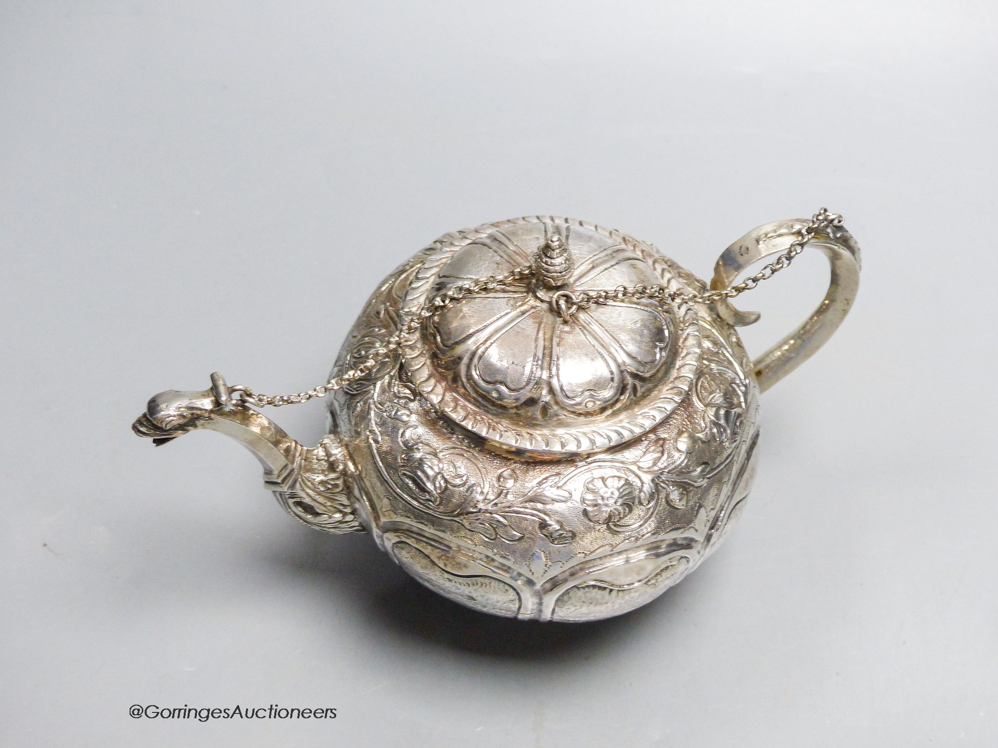 A late 18th/early 19th century Dutch? embossed white metal teapot, 13.5cm, gross 11.5oz